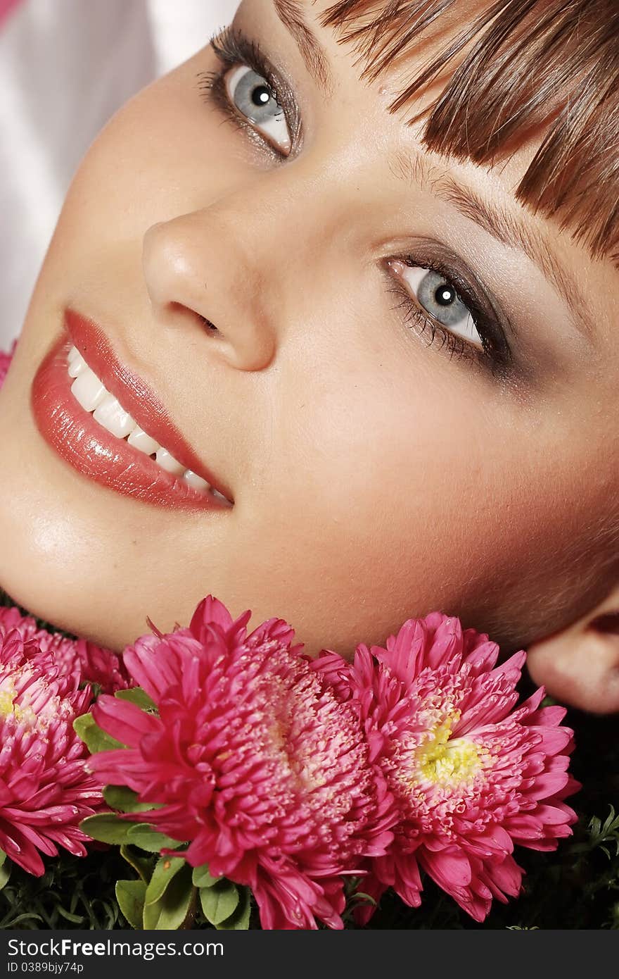 Portrait of a young woman with pink flowers. Portrait of a young woman with pink flowers