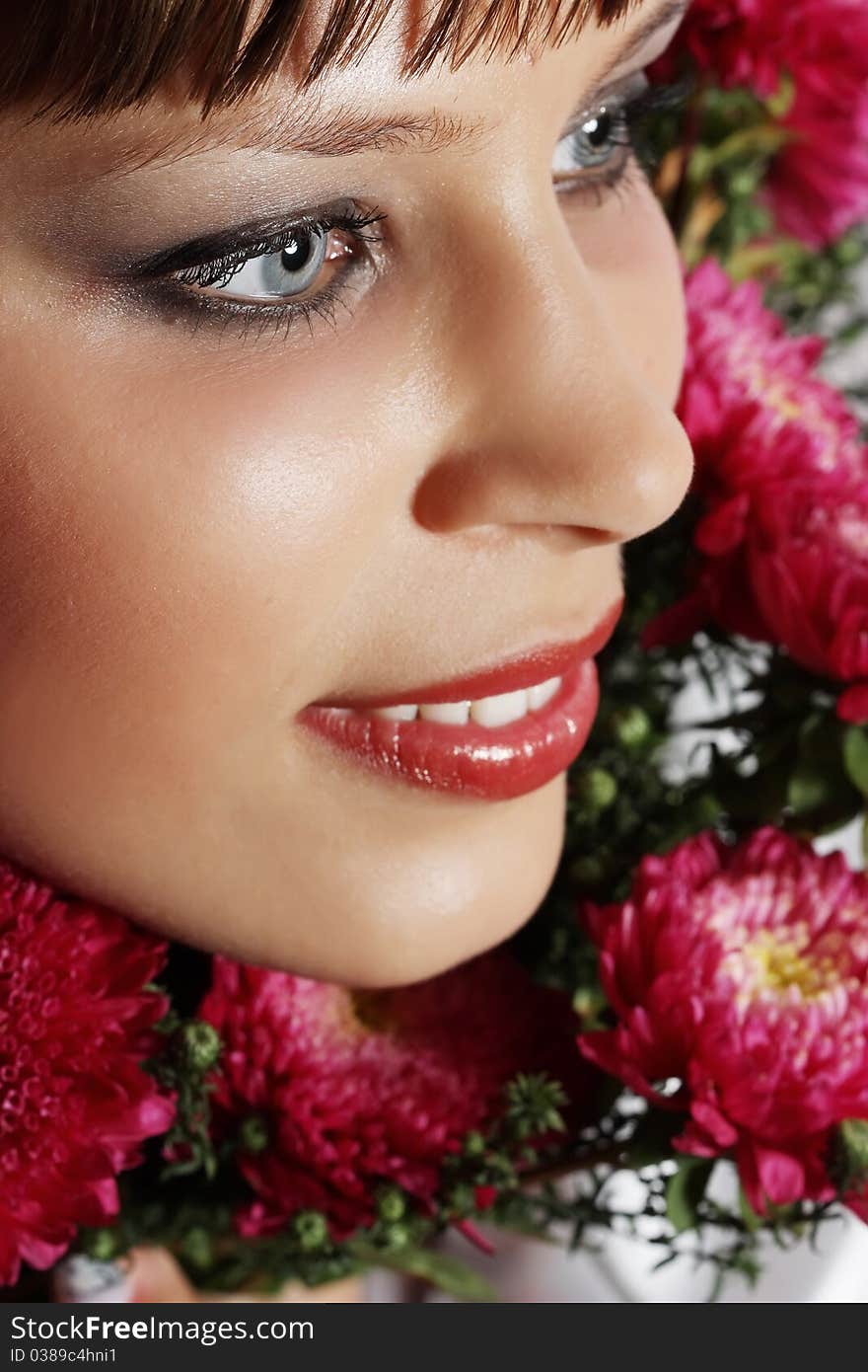 Portrait of a young woman with pink flowers. Portrait of a young woman with pink flowers