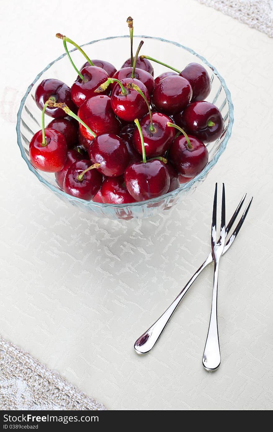 A bowl of fresh cherry with two fruit fork for couple. A bowl of fresh cherry with two fruit fork for couple.