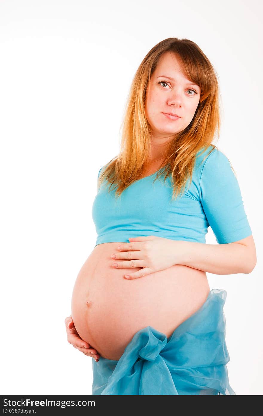 Beautiful pregnant woman staying on white background