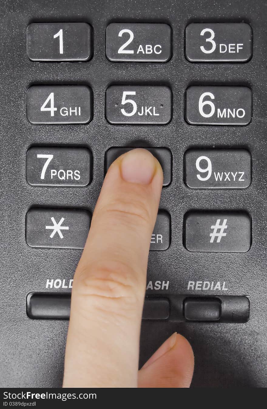 One human finger pressing key on phone