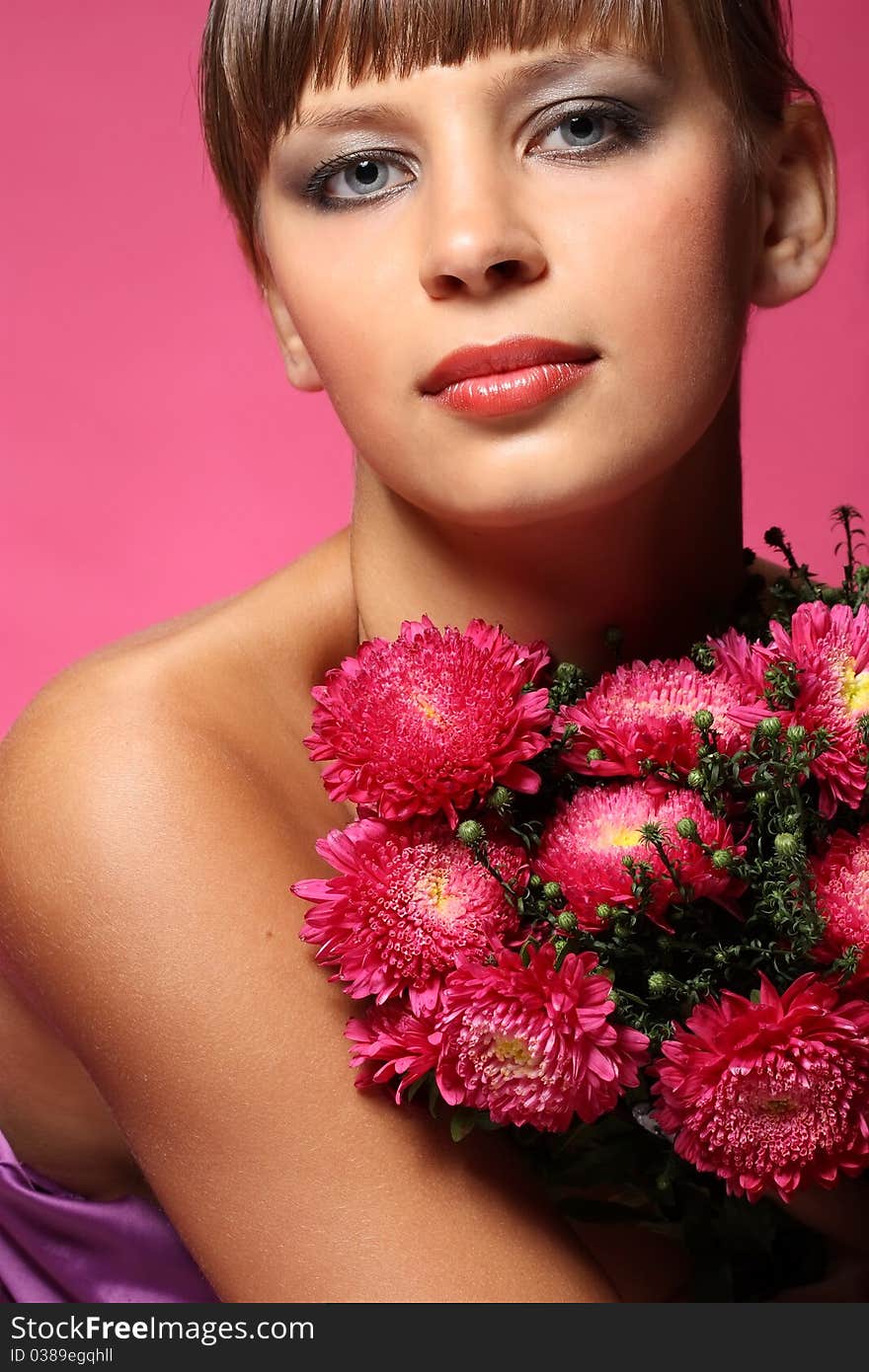 Portrait of a young woman with pink flowers. Portrait of a young woman with pink flowers