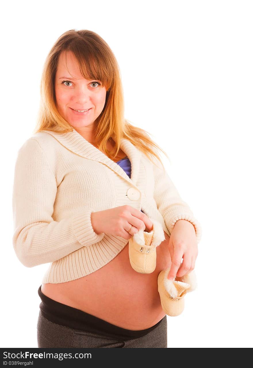 Pregnant woman holding pair of baby's bootee. Pregnant woman holding pair of baby's bootee