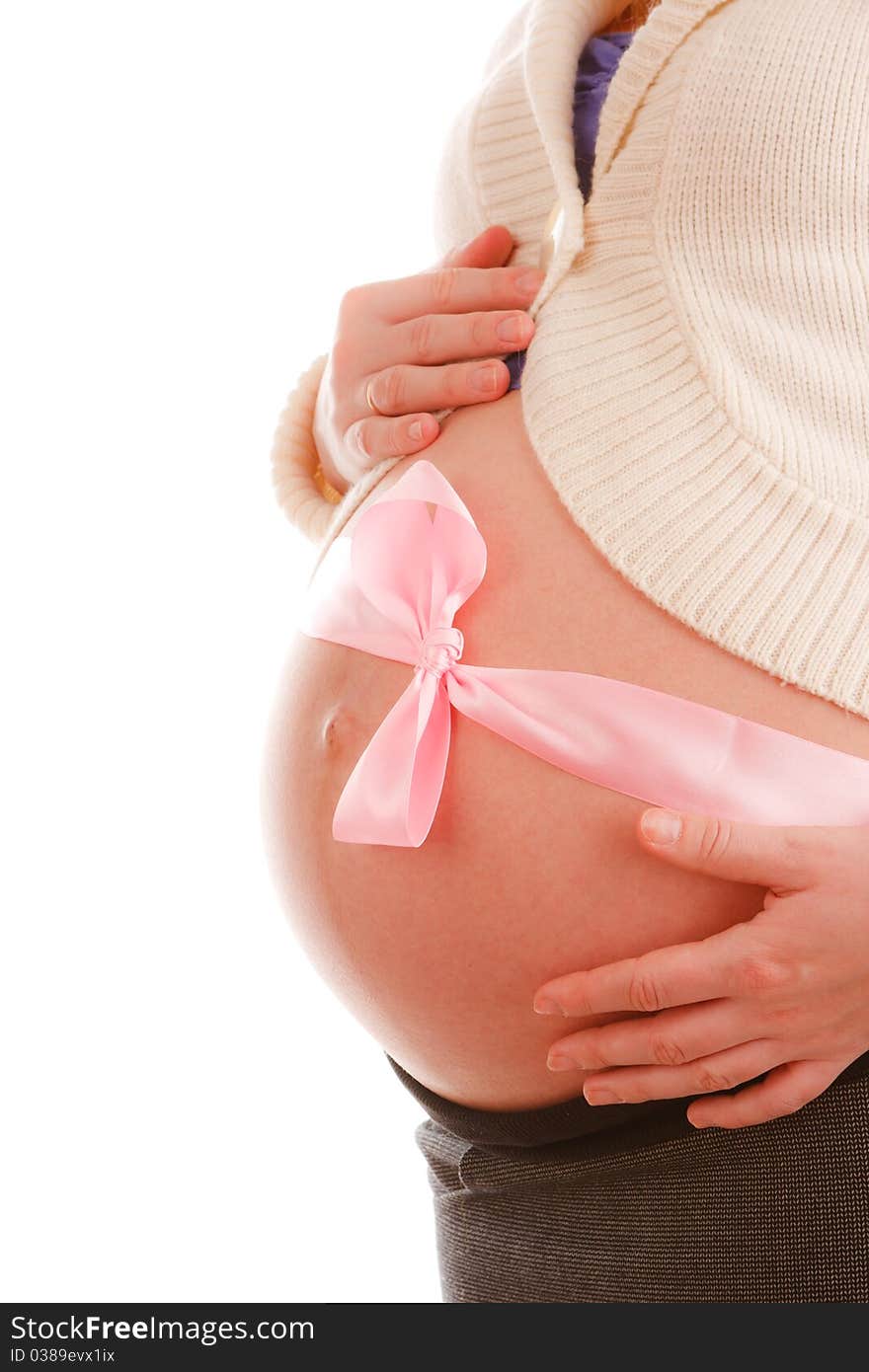 Belly of a pregnant woman with pink ribbon on white background. Belly of a pregnant woman with pink ribbon on white background