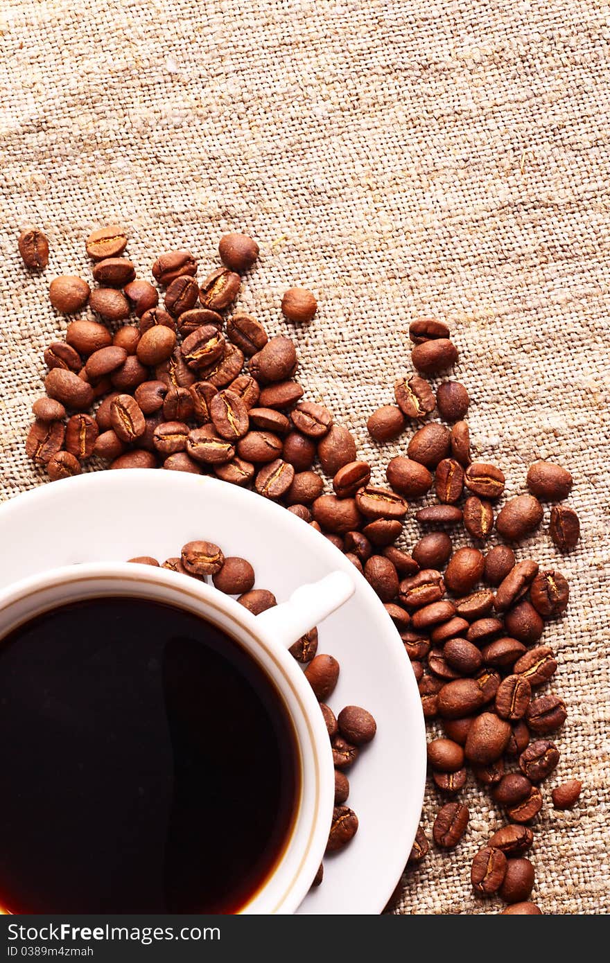 Coffee cup and grain onon a fabric. Still-life