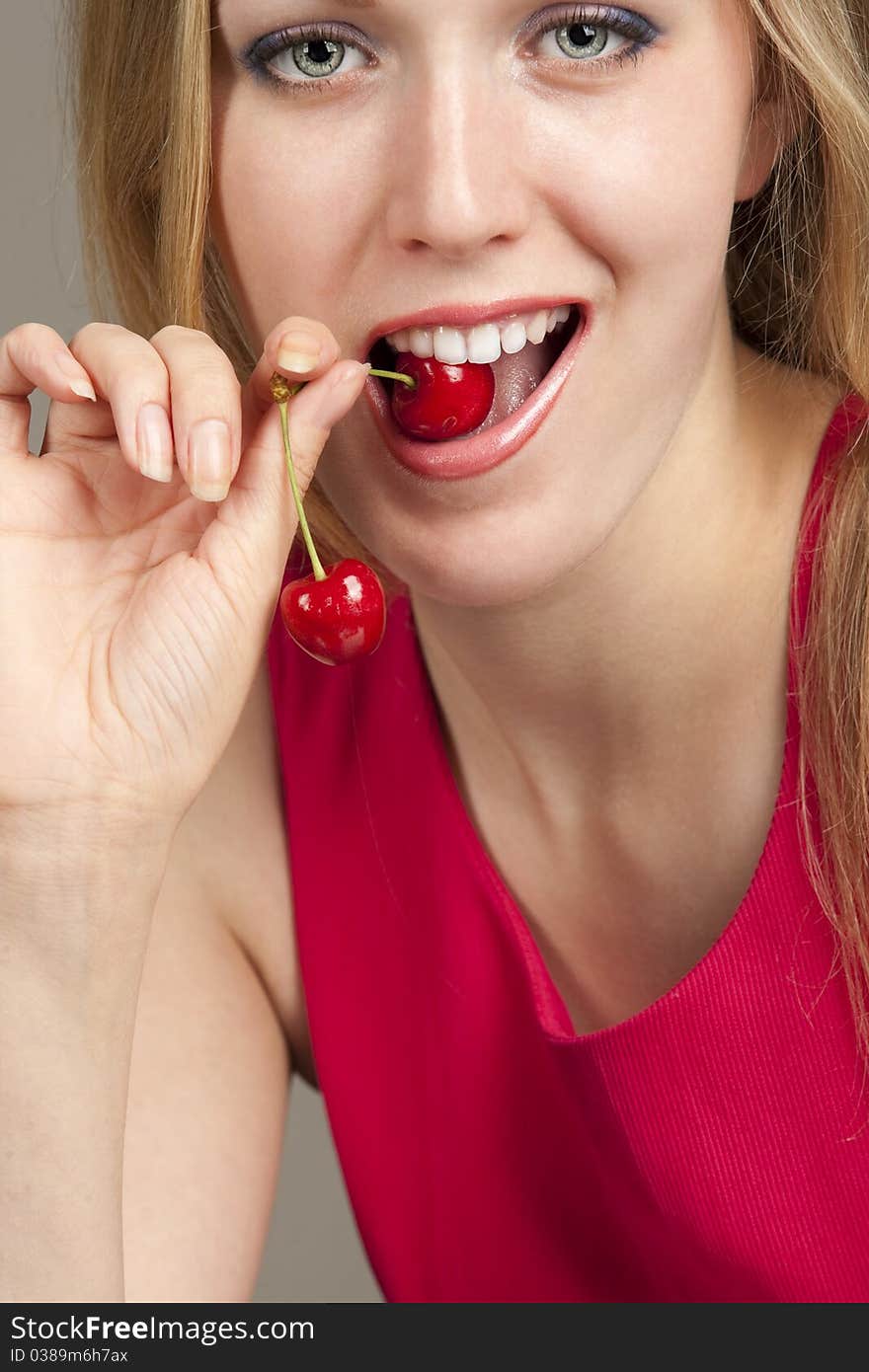 Sexy young woman eating red cherries. Sexy young woman eating red cherries