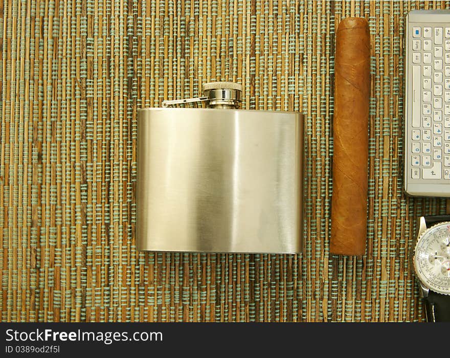 Close up of cigar, hip flask, wristwatch and cell phone. Background. Close up of cigar, hip flask, wristwatch and cell phone. Background