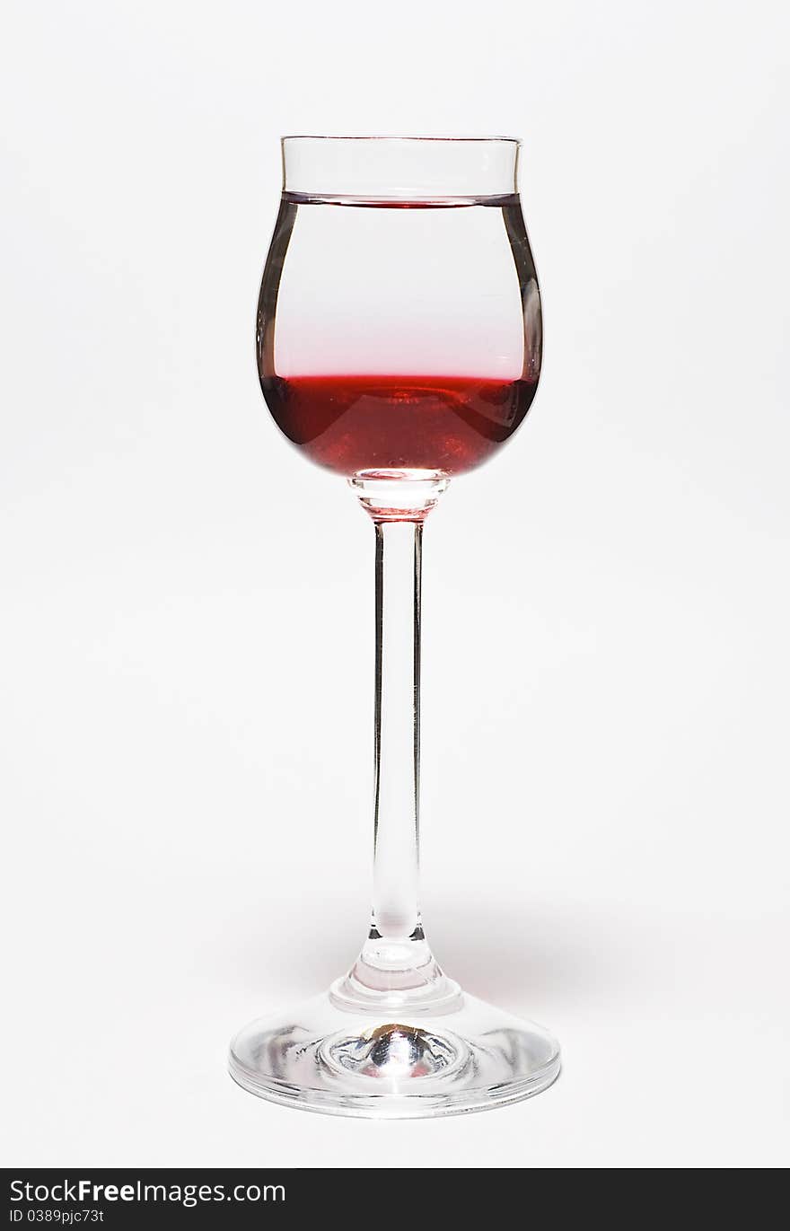 Glass for vodka with drink on white background