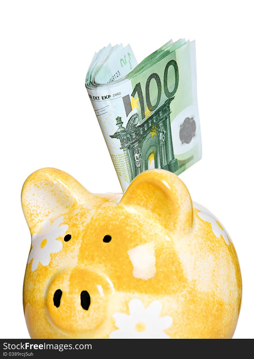 Yellow ceramic piggy bank, full of European banknotes. Yellow ceramic piggy bank, full of European banknotes