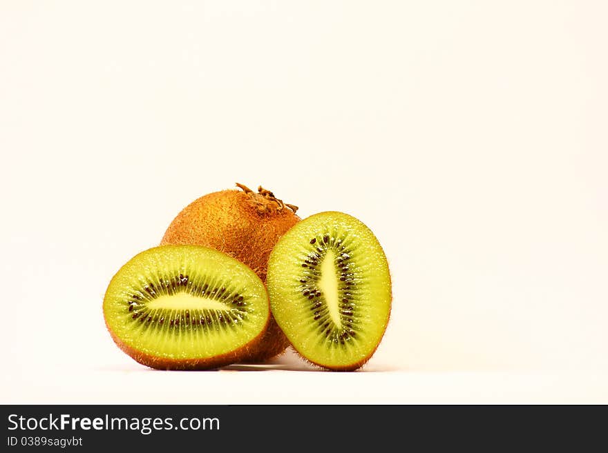 Fresh pieces of kiwi fruit on white background