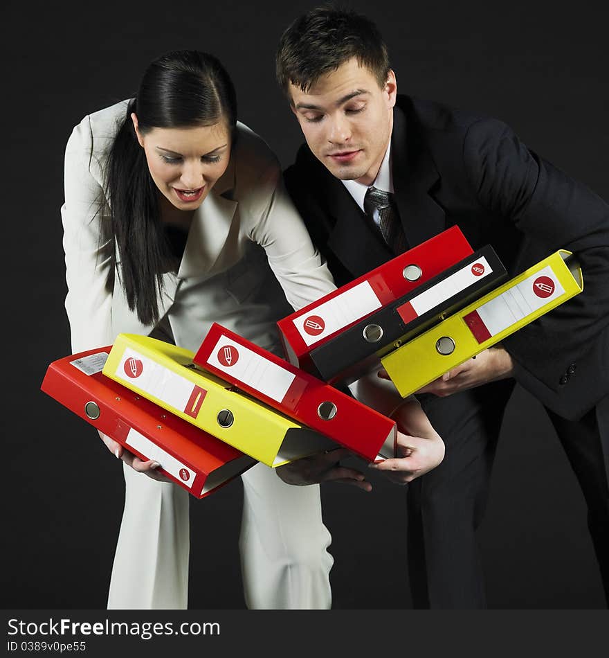 Young businessman and woman holding files. Young businessman and woman holding files