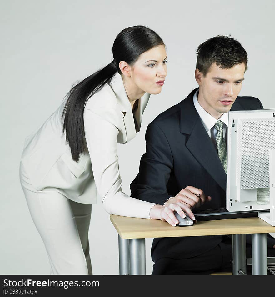 Businesswoman and businessman at computer. Businesswoman and businessman at computer