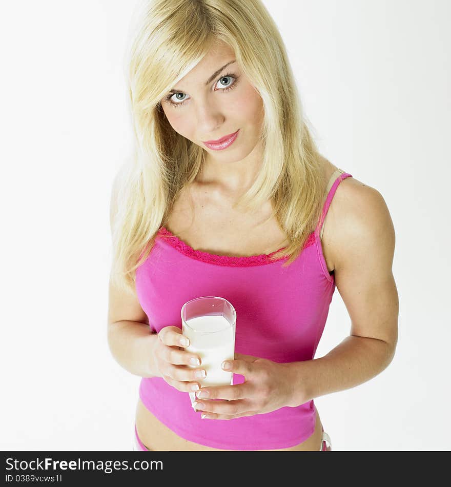 Portrait of young woman with a glass of milk