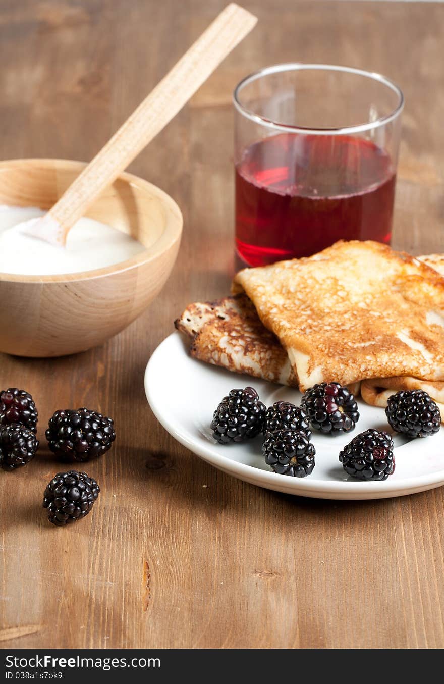 Breakfast with pancakes, yogurt  and blackberries