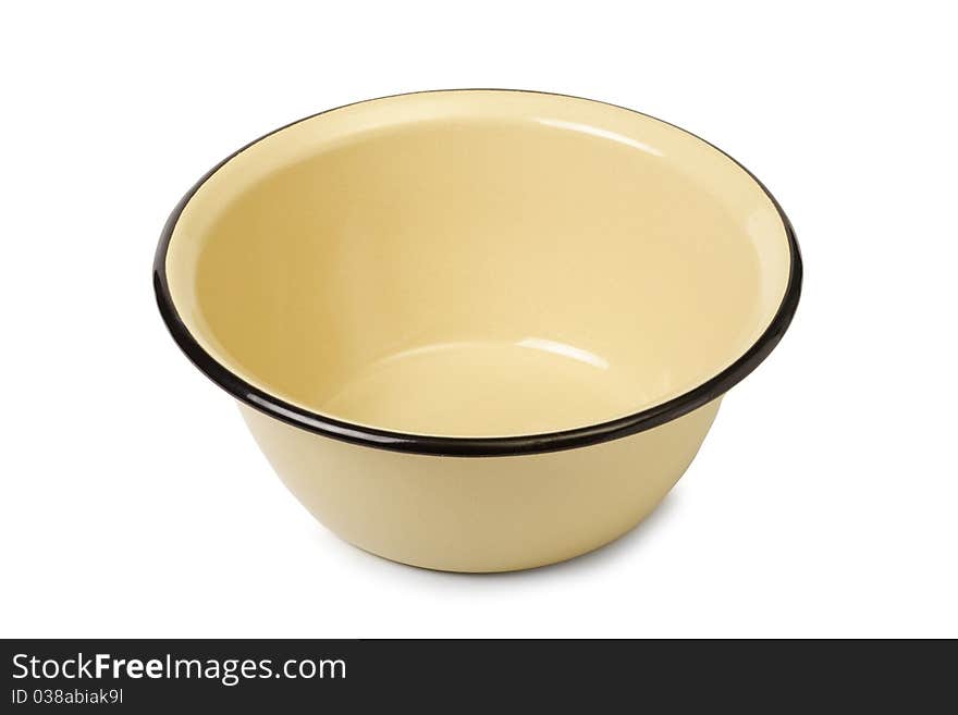 The yellow enameled plate is isolated on a white background. The yellow enameled plate is isolated on a white background