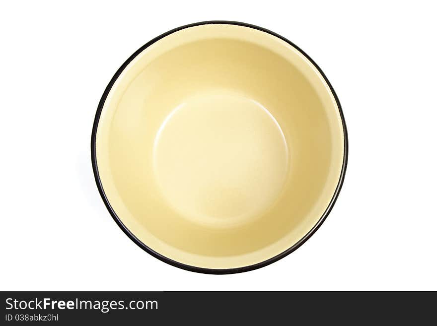 The yellow enameled plate is isolated on a white background. The yellow enameled plate is isolated on a white background