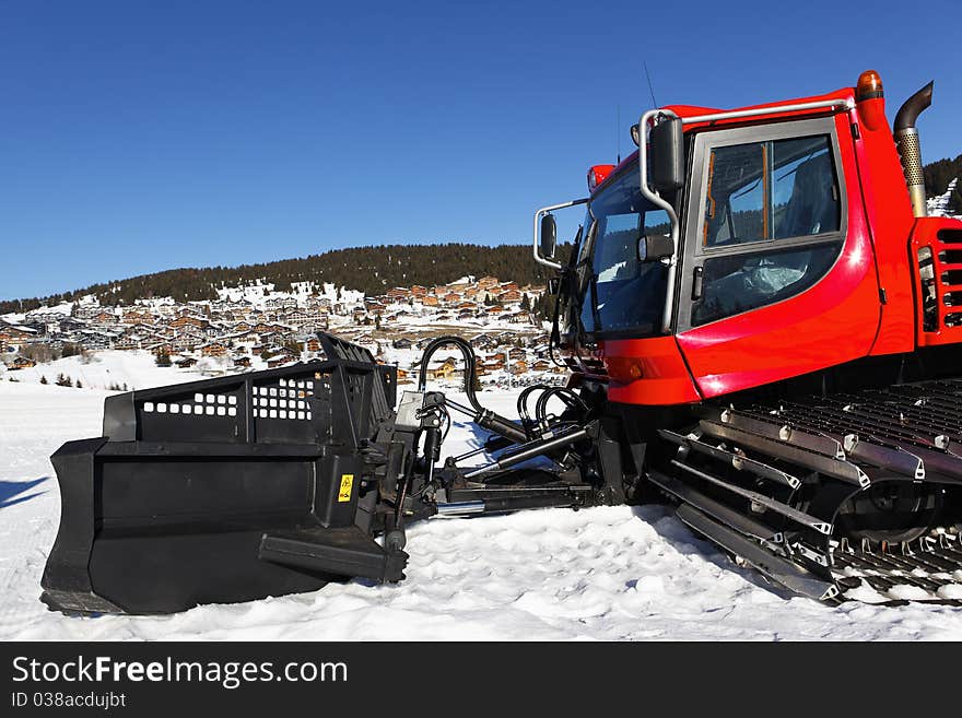 Red snoplow on ski track. Red snoplow on ski track