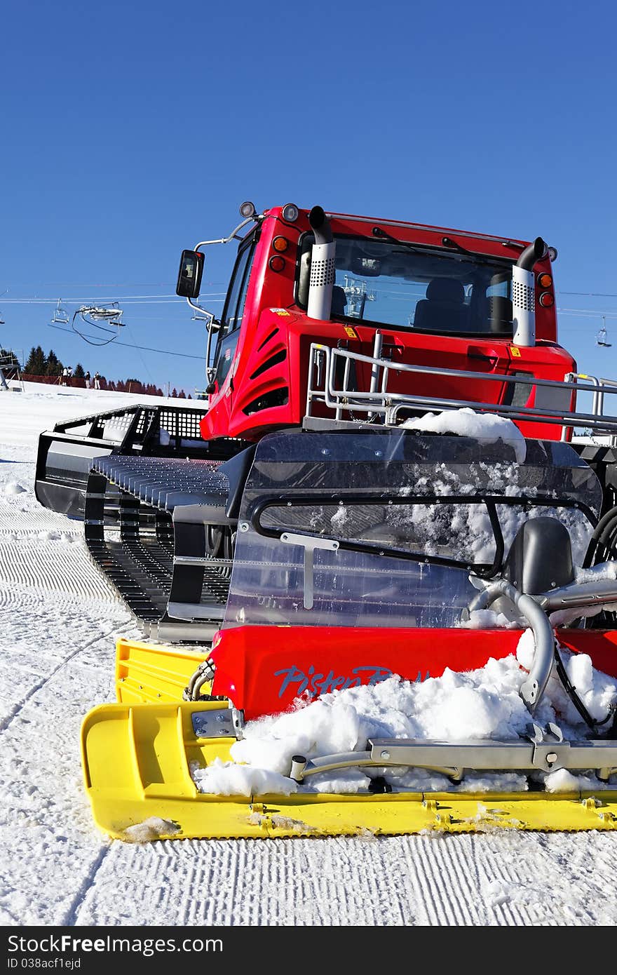 Red snoplow on ski track. Red snoplow on ski track