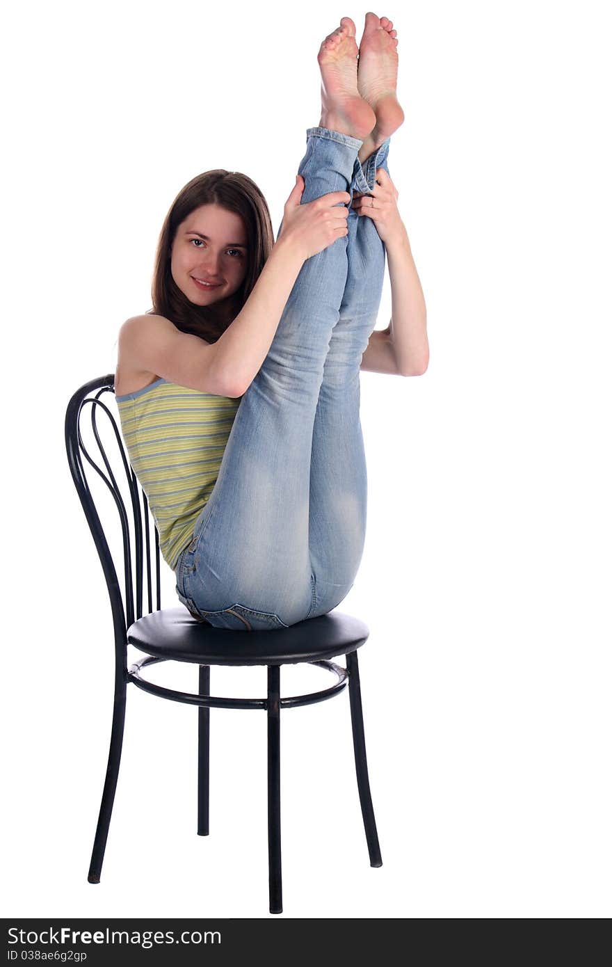 Girl in green stripy top sit on stool take legs up. Isolated on white. Girl in green stripy top sit on stool take legs up. Isolated on white.