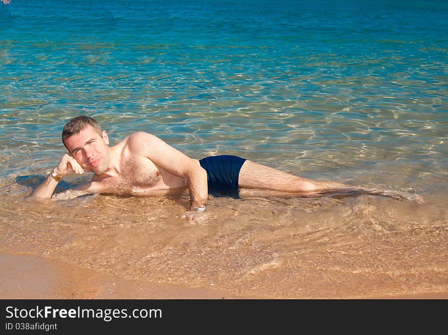 Beautiful  man on sea with beach. Nature