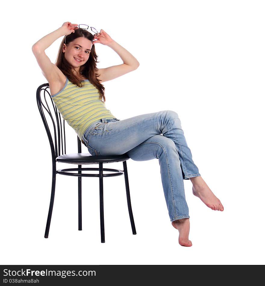 Girl in green stripy top sit on stool taking off glasses. Isolated on white. Girl in green stripy top sit on stool taking off glasses. Isolated on white.