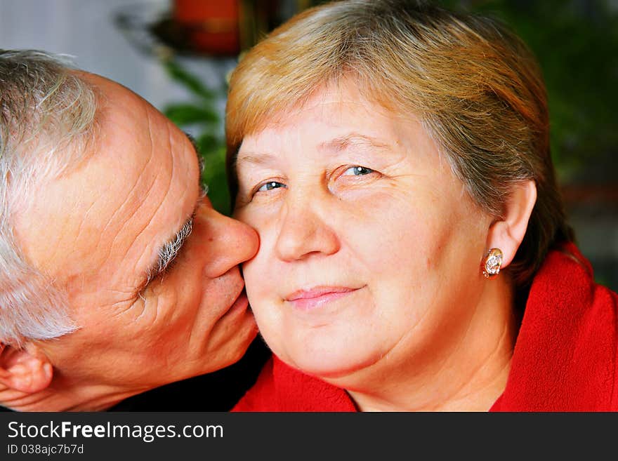 Happy senior lovely couple kissing. Happy senior lovely couple kissing