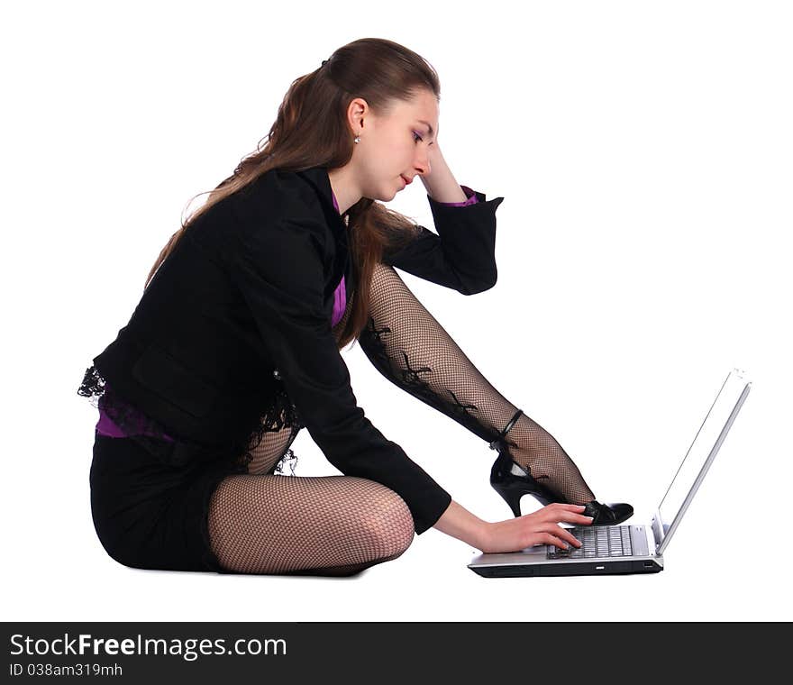 Girl in black suit sits on floor and works with notebook. Isolated on white. Girl in black suit sits on floor and works with notebook. Isolated on white.