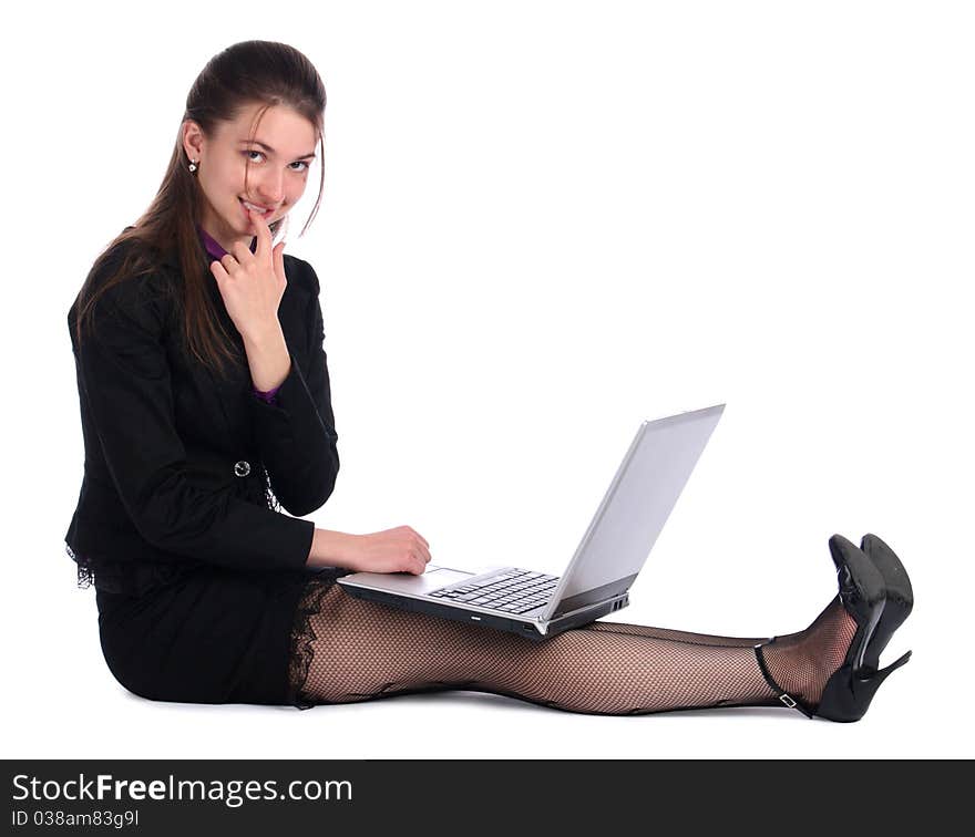 Girl in black suit with notebook sit on floor.