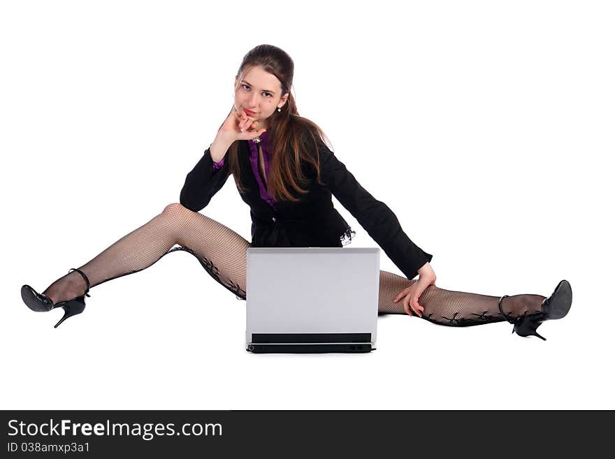 Girl in black suit with notebook sits on floor.