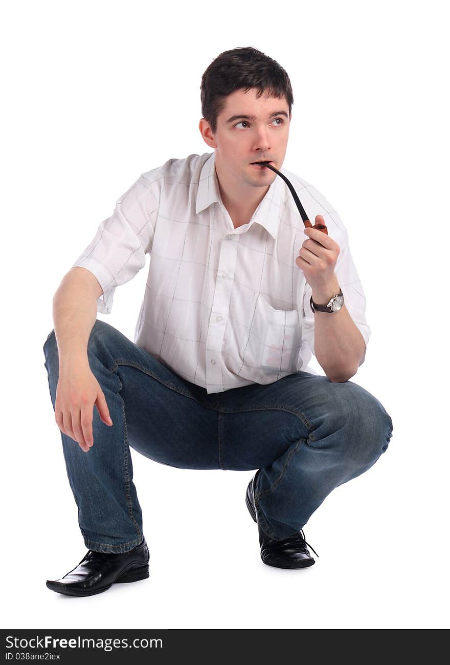 Young man with pipe sits. Isolated on white.