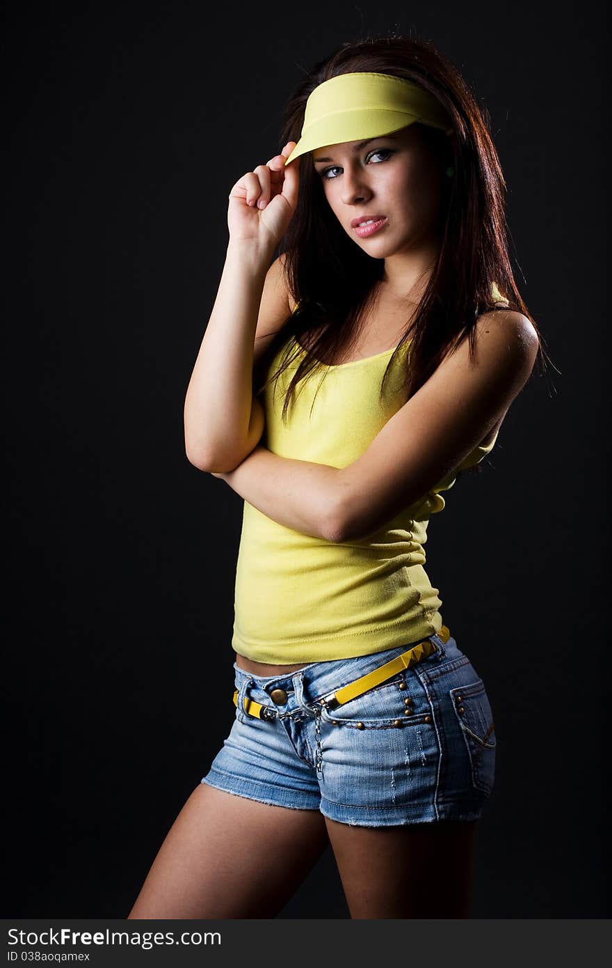 Portrait of beautiful young woman posing on dark background