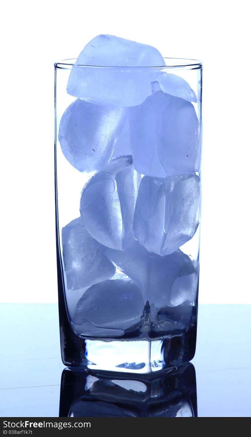 Glass filled with ice cubes . Glass filled with ice cubes .