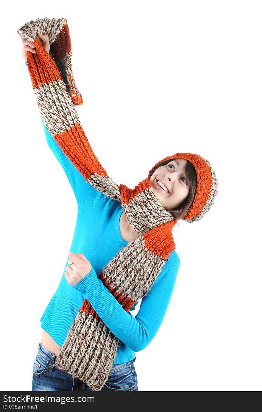 Happy beautiful girl wearing a hat and scarf isolated against white background