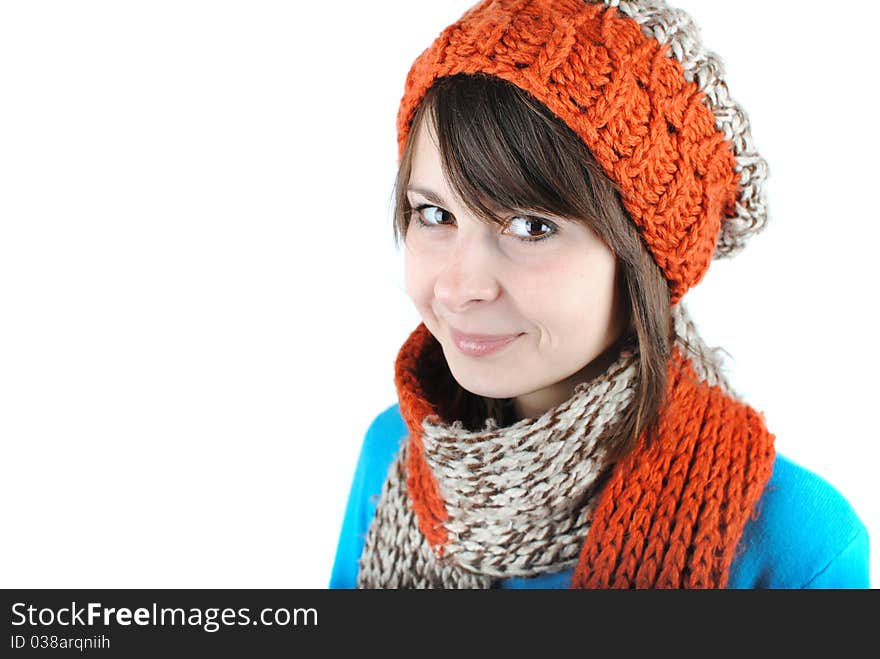 Happy beautiful girl wearing a hat and scarf isolated against white background