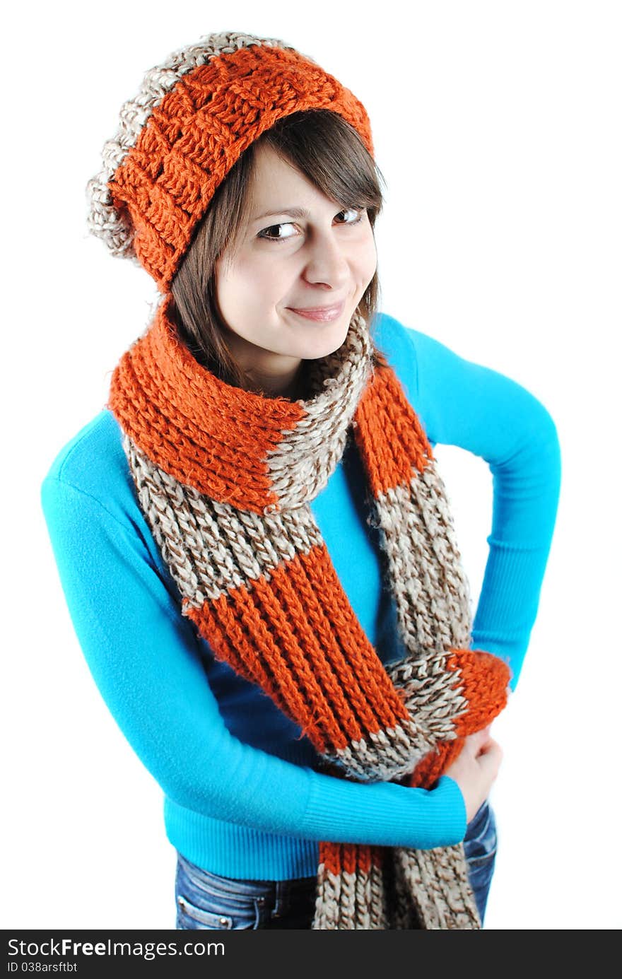 Happy beautiful girl wearing a hat and scarf isolated against white background