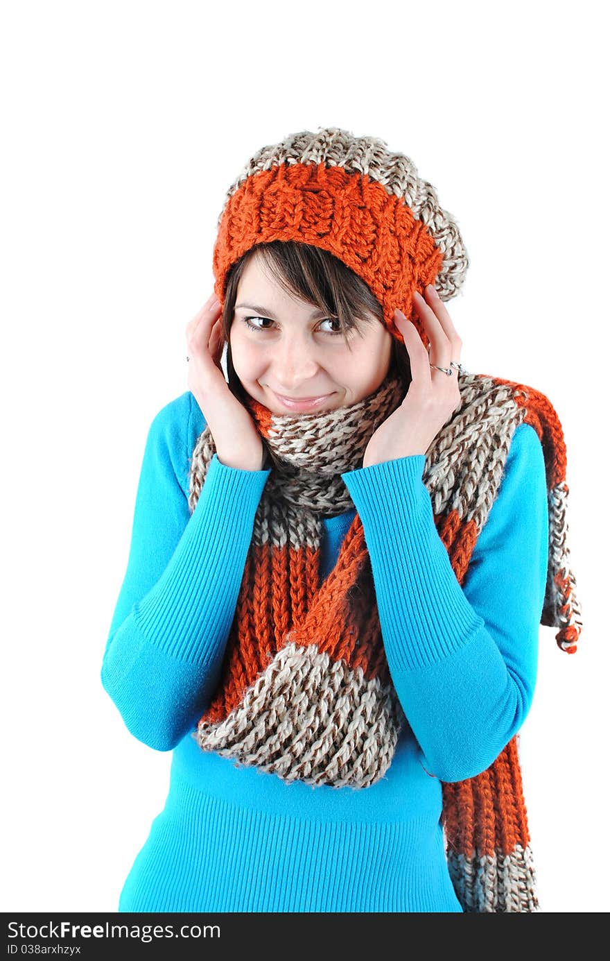 Happy beautiful girl wearing a hat and scarf isolated against white background