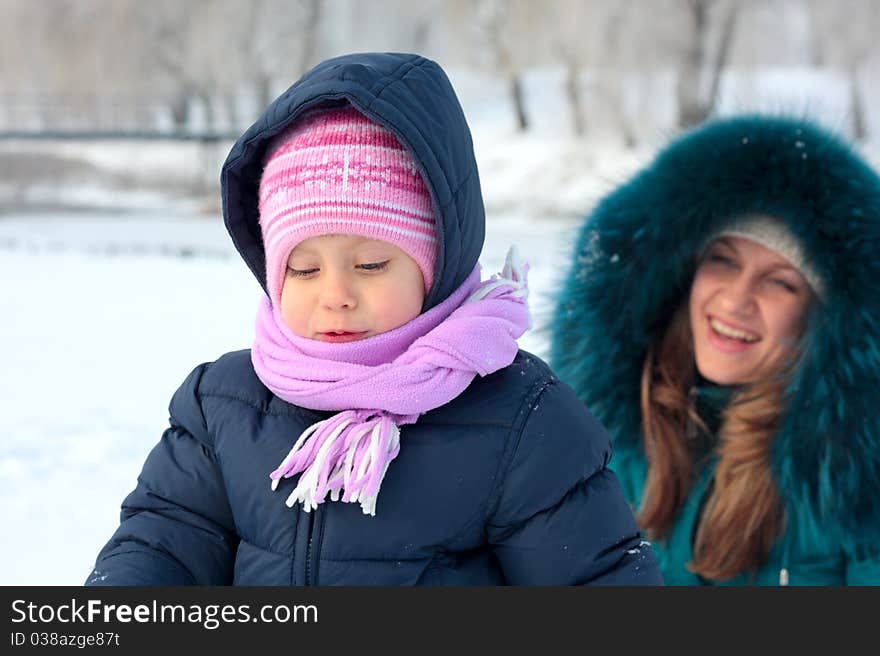 Mother and  kid having fun outdoors on  winter day