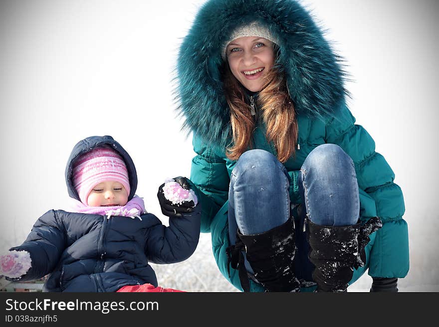 Mother and  kid having fun outdoors on  winter day