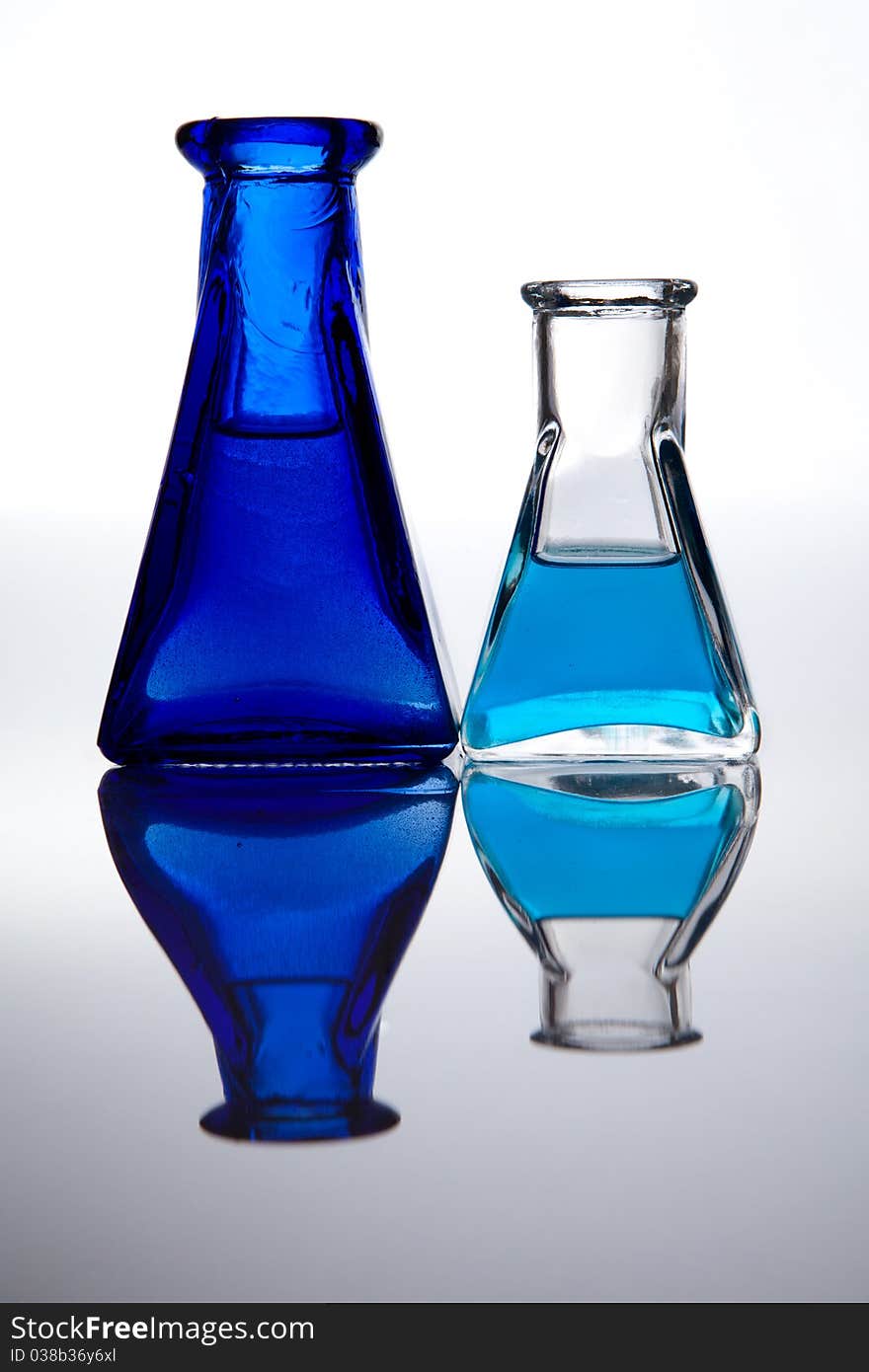 Two decorative flasks containing liquid color. Two decorative flasks containing liquid color