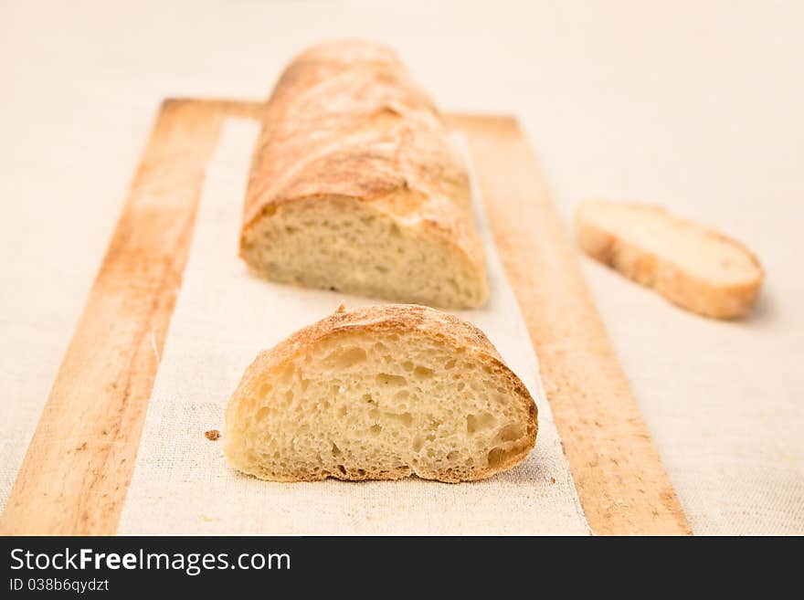 Homemade loaf with slice aside on a wooden board. Homemade loaf with slice aside on a wooden board.