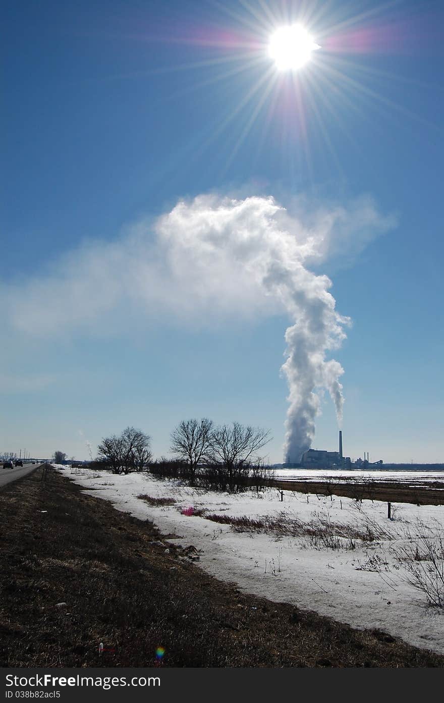 This steam makes a glorious shape in the distance as the sun looks on. This steam makes a glorious shape in the distance as the sun looks on.