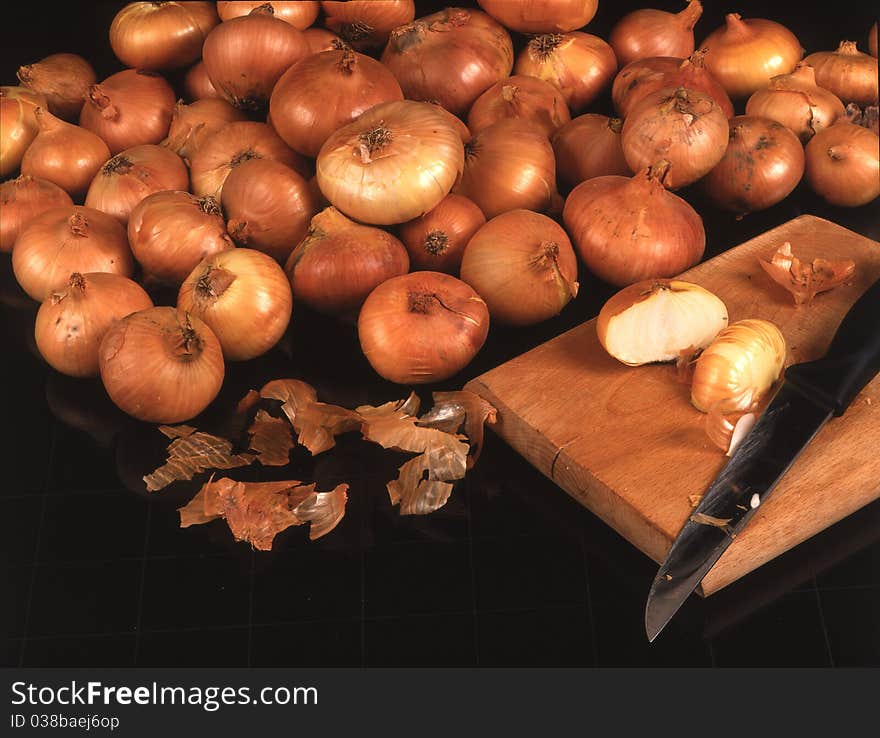 onion with knife on black background