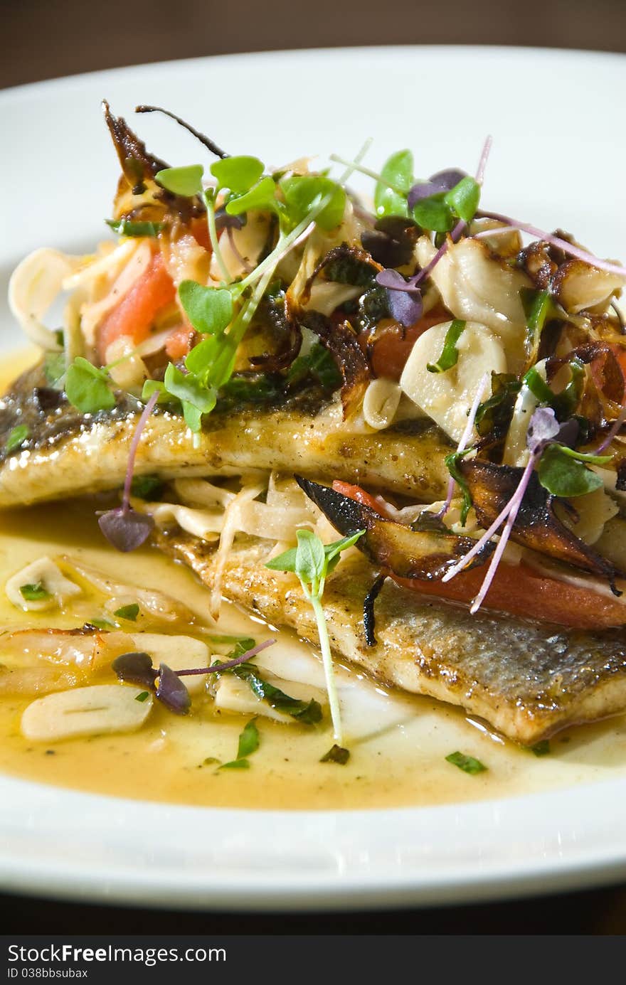 Roasted branzino with fresh herbs and vegetables. Roasted branzino with fresh herbs and vegetables