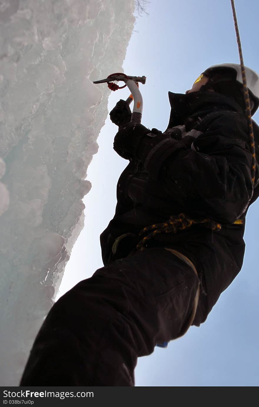 A man climbing a frozen waterfall. A man climbing a frozen waterfall.