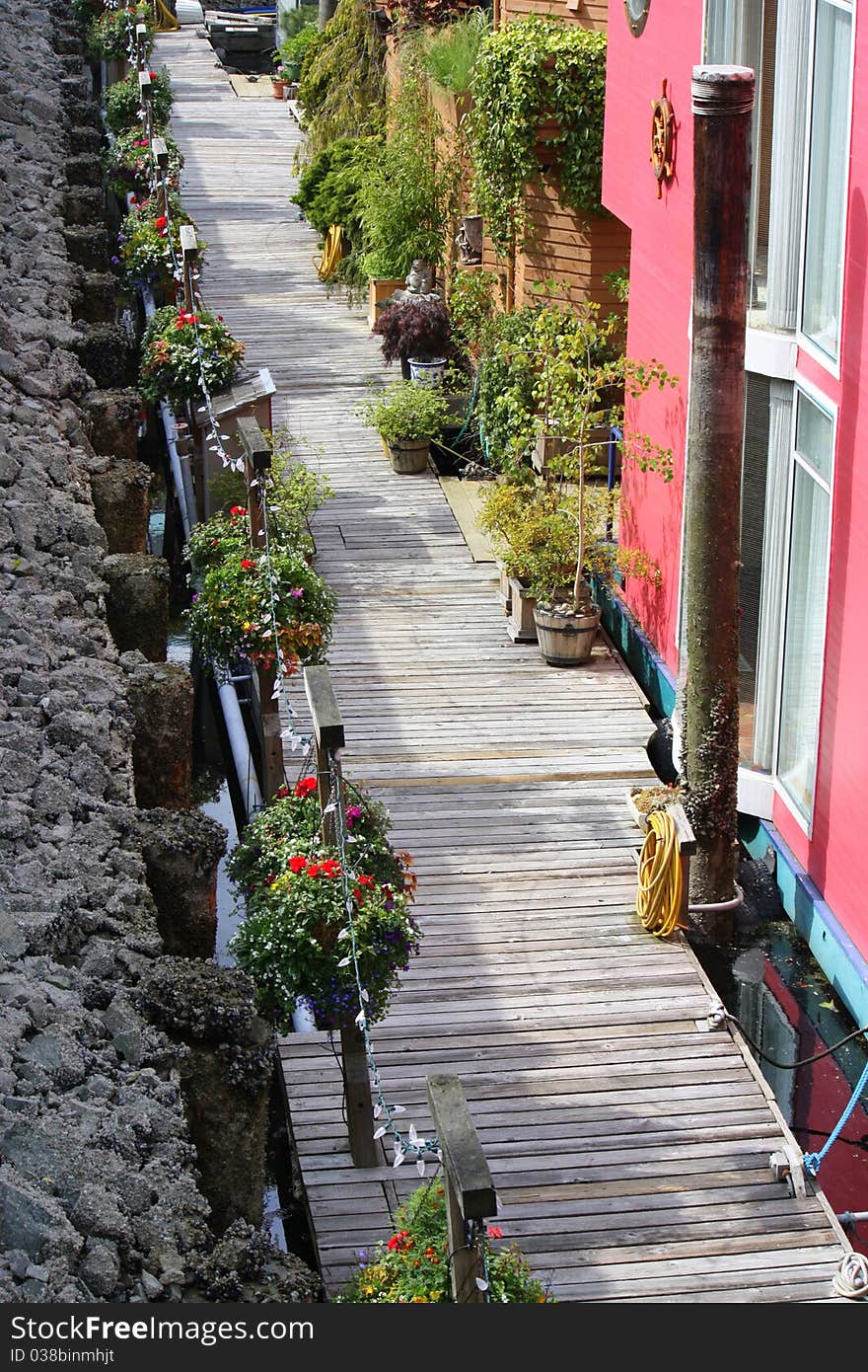 Wooden deck walkway along houseboats. Wooden deck walkway along houseboats