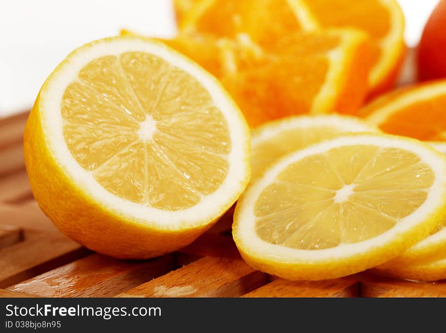 Lemon slices with oranges in the background