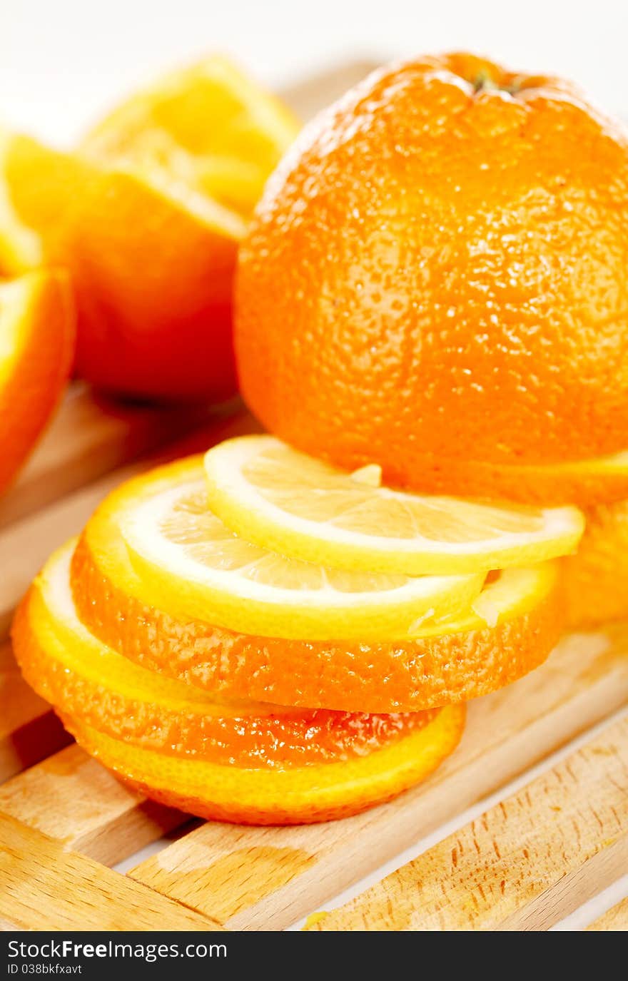 Slices of an orange placed on a wooden plate. Slices of an orange placed on a wooden plate