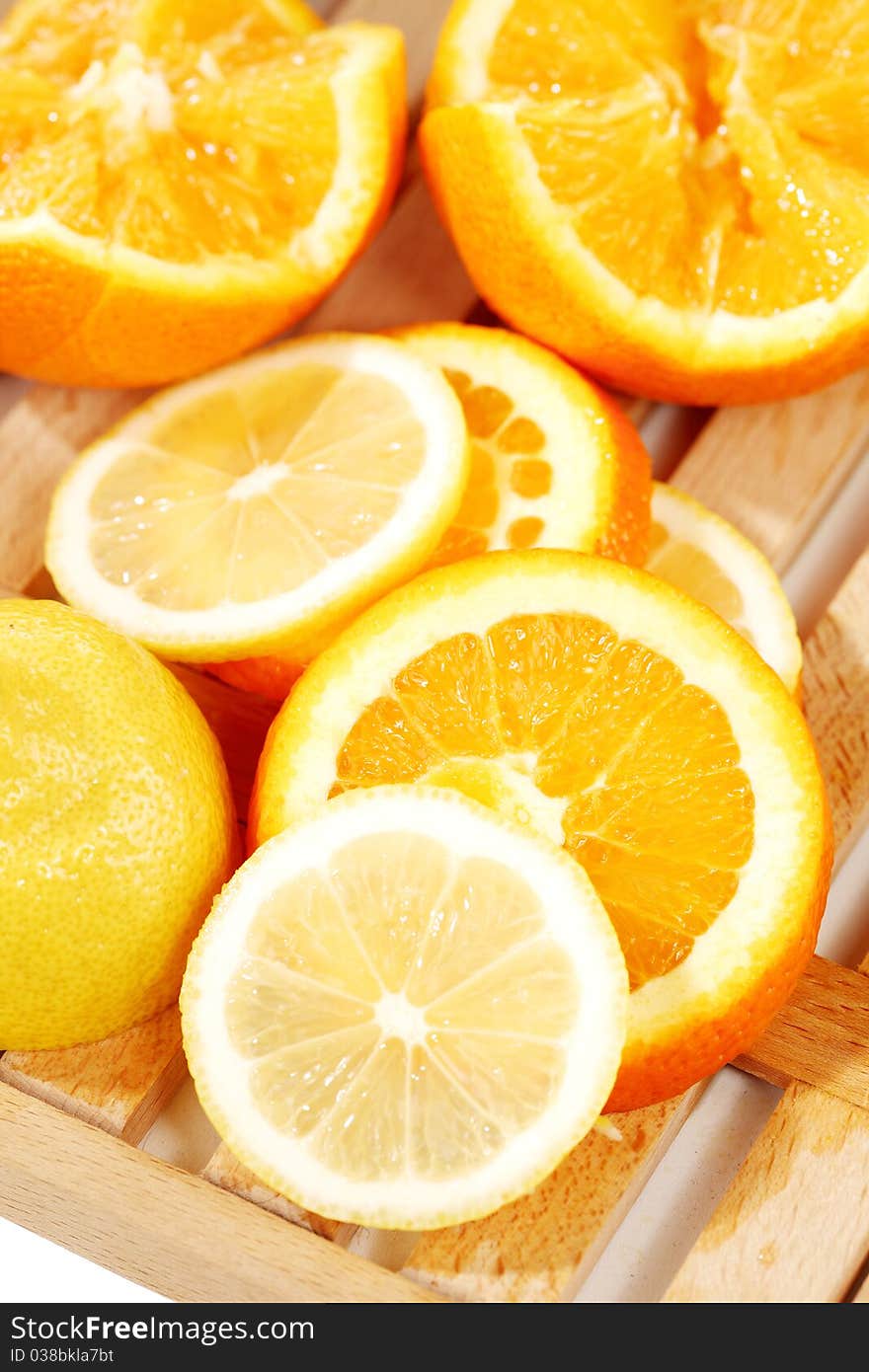 Slices of the orange placed on a wooden plate. Slices of the orange placed on a wooden plate