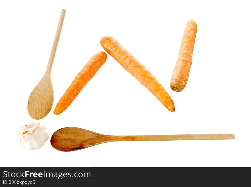 Ladles, carrots and garlik on a white background making a chart shape, with clipping path. Ladles, carrots and garlik on a white background making a chart shape, with clipping path