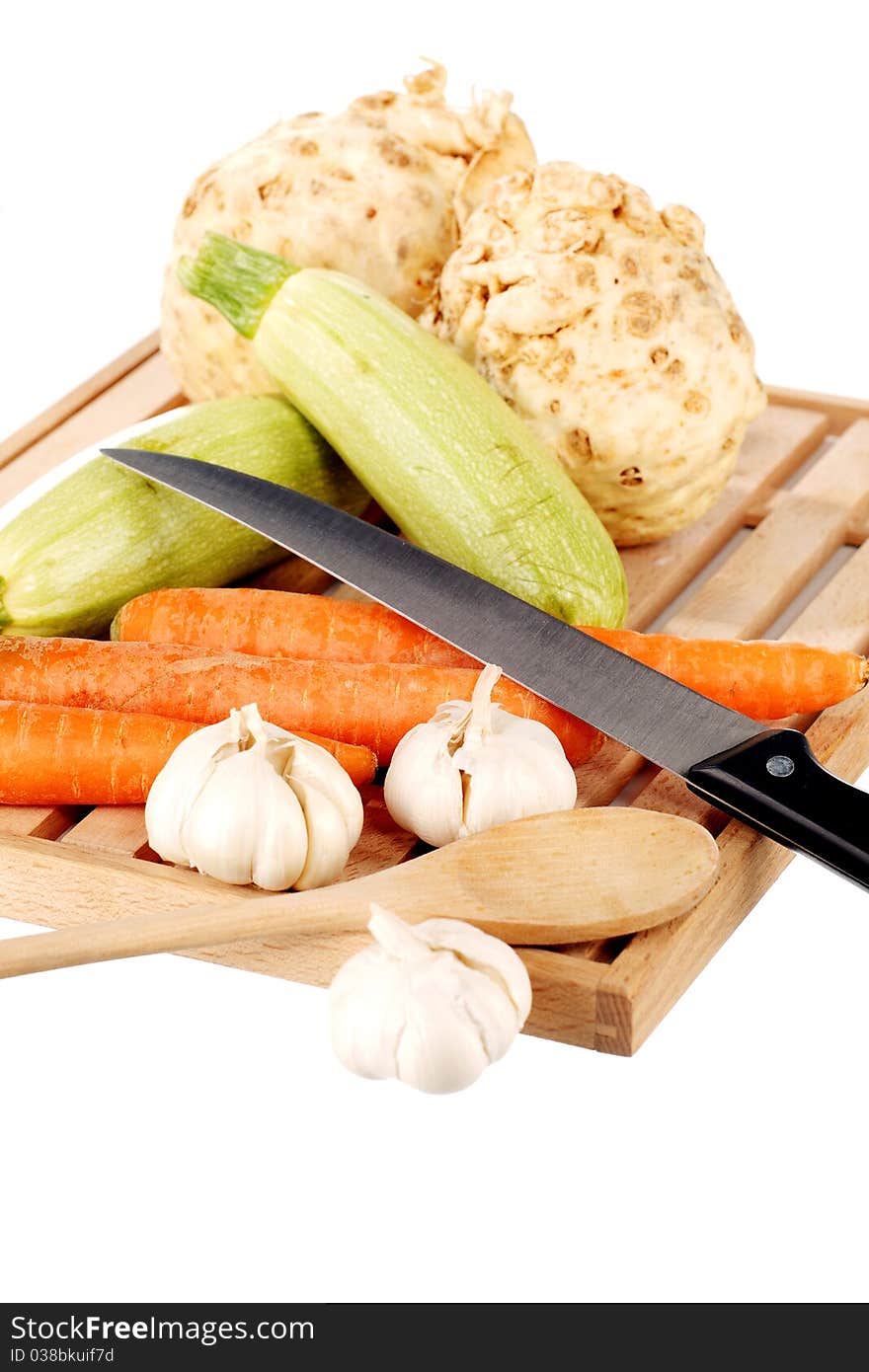 Vegetable mix and knife on a wooden plate. Vegetable mix and knife on a wooden plate